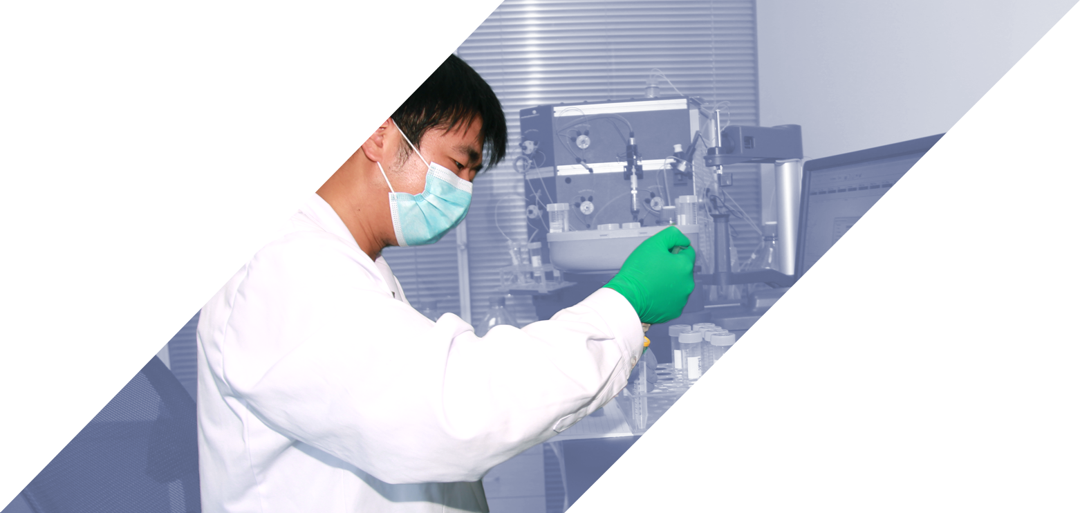 Male scientist at lab bench filling vials